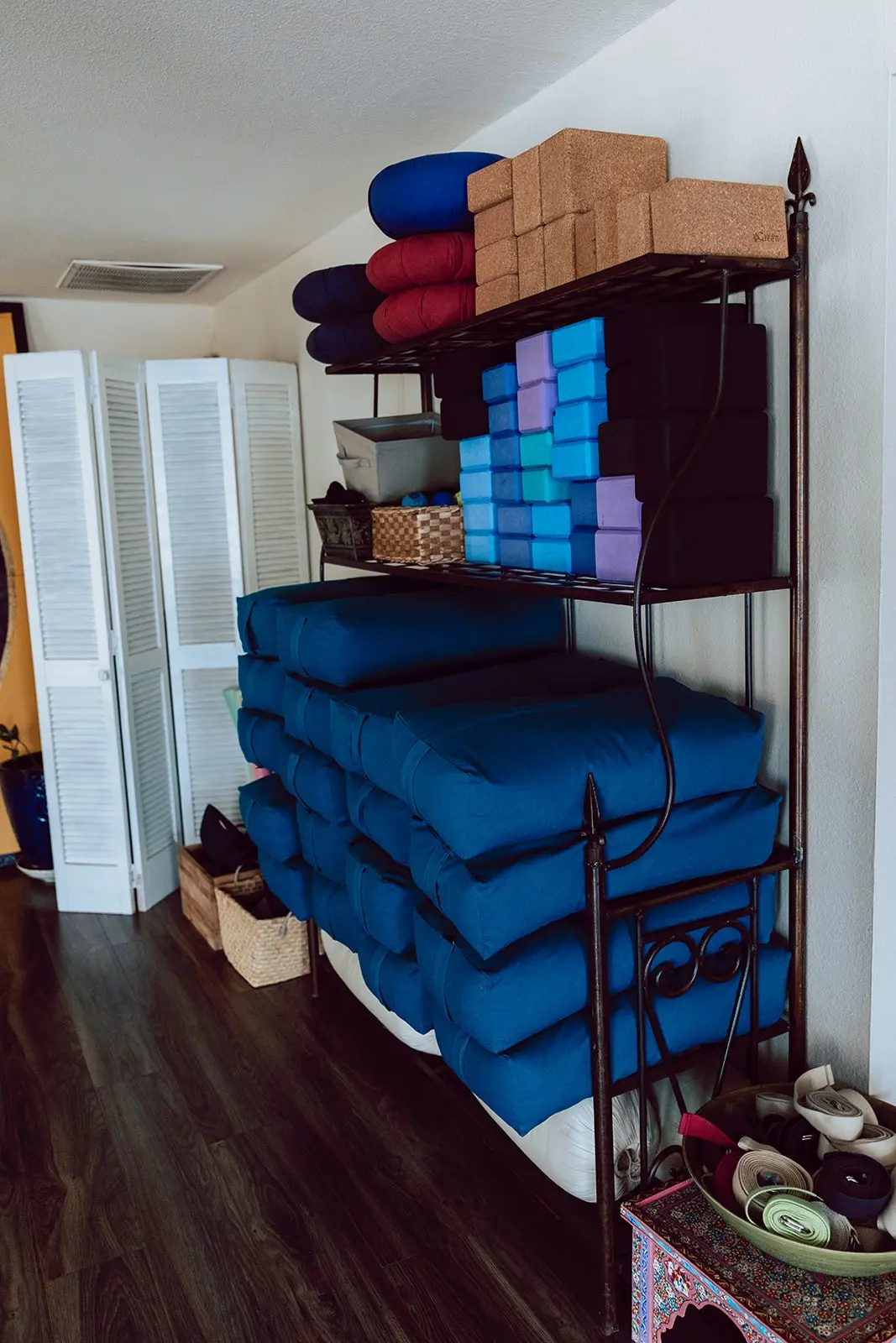 Rack of blue bolsters, cork blocks and straps in the studio